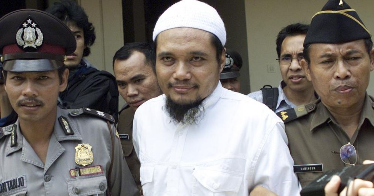 Abu Rusdan is seen being escorted by security in Jakarta, Indonesia, on Nov. 3, 2003.