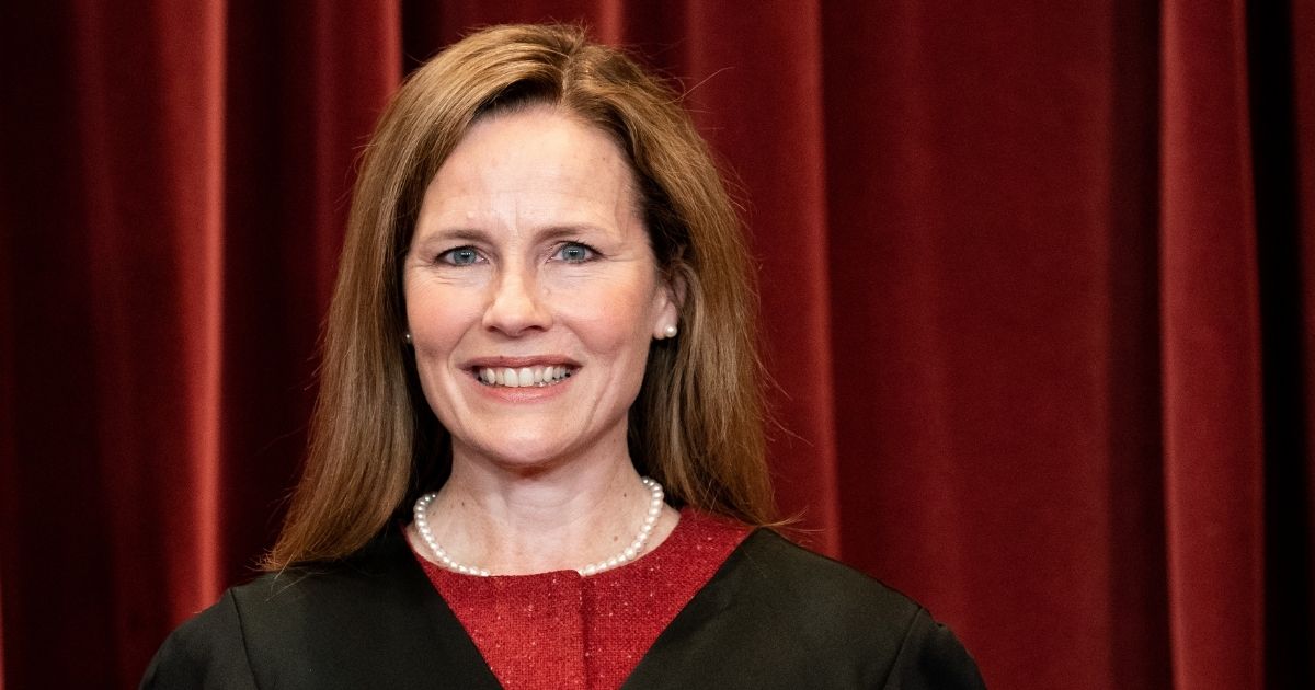 Associate Justice Amy Coney Barrett poses for a group photo with the other Justices at the Supreme Court in Washington, D.C., on April 23, 2021.