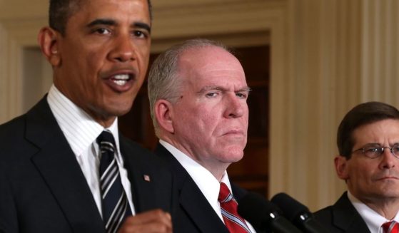 CIA Director Michael Morell and Deputy National Security Advisor for Homeland Security and Counterterrorism John Brennan stand beside former President Barack Obama during a speech he gave in the White House’s East Room on Jan. 7, 2013.