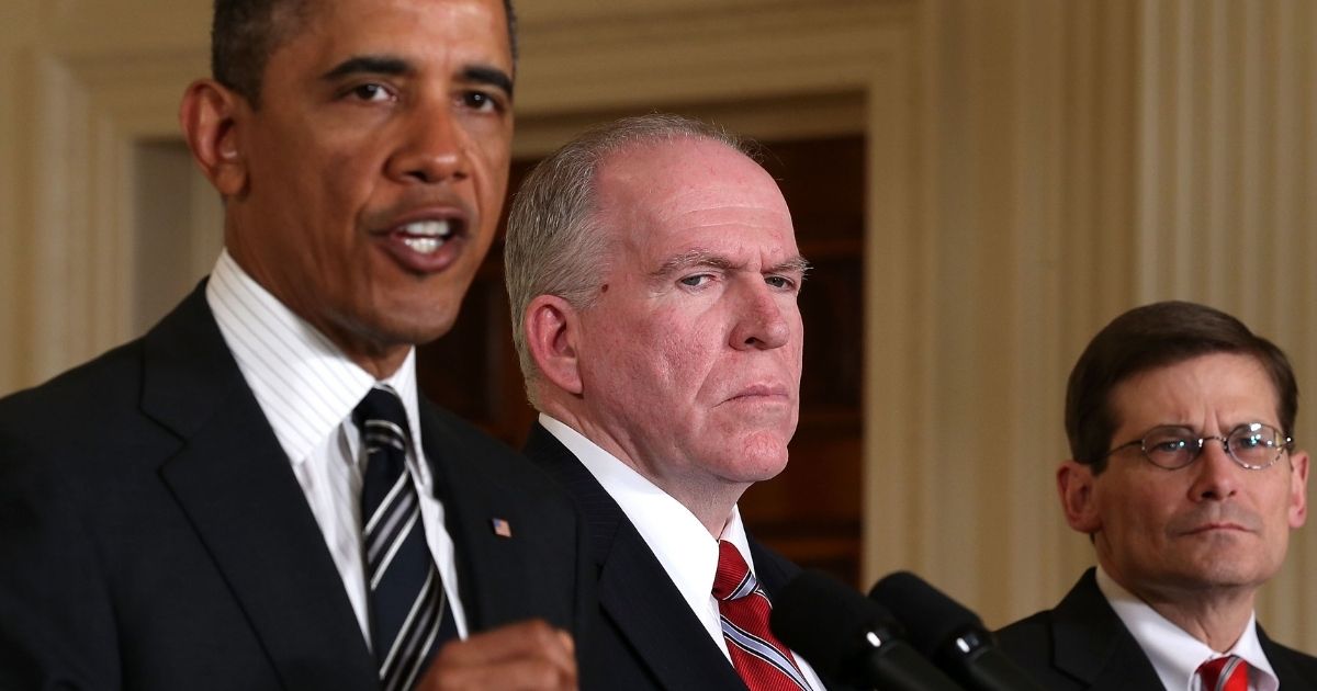 CIA Director Michael Morell and Deputy National Security Advisor for Homeland Security and Counterterrorism John Brennan stand beside former President Barack Obama during a speech he gave in the White House’s East Room on Jan. 7, 2013.