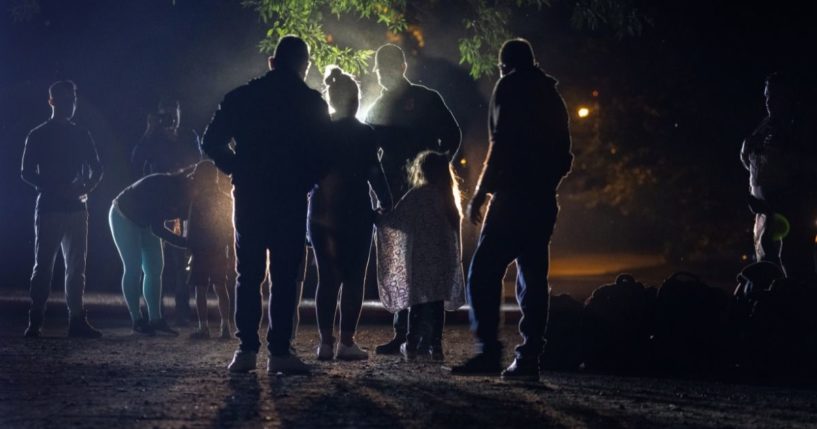 A Border Patrol agent is seen speaking with a Venezuelan family seeking asylum in Del Rio, Texas, on May 19.