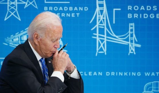 President Joe Biden puts his head to his hands during a virtual meeting with governors, mayors and local officials in August.