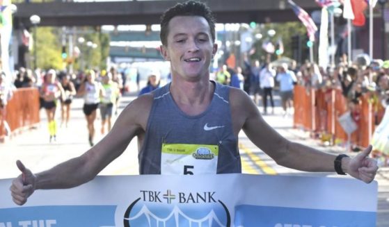 Tyler Pence is seen crossing the finish line at the TBK Bank Quad Cities Marathon in Moline, Illinois, on Sunday.