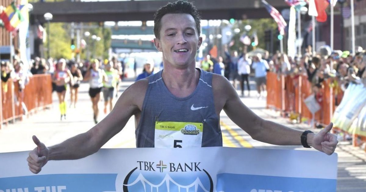 Tyler Pence is seen crossing the finish line at the TBK Bank Quad Cities Marathon in Moline, Illinois, on Sunday.