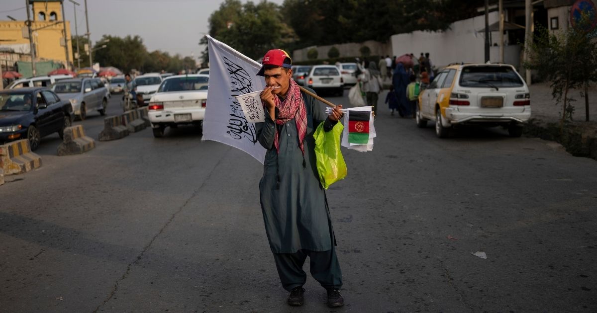 A street vendor is seen selling Taliban and Afghan flags in Kabul, Afghanistan, on Thursday.