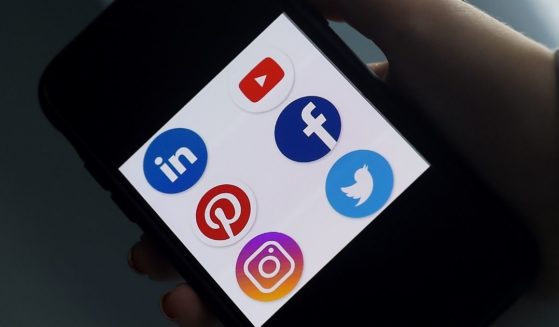 Social media application logos for Linkedin, YouTube, Pinterest, Facebook, Instagram and Twitter are seen on a smartphone in Arlington, Virginia, on May 28.