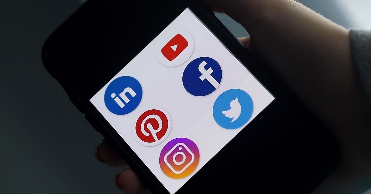 Social media application logos for Linkedin, YouTube, Pinterest, Facebook, Instagram and Twitter are seen on a smartphone in Arlington, Virginia, on May 28.