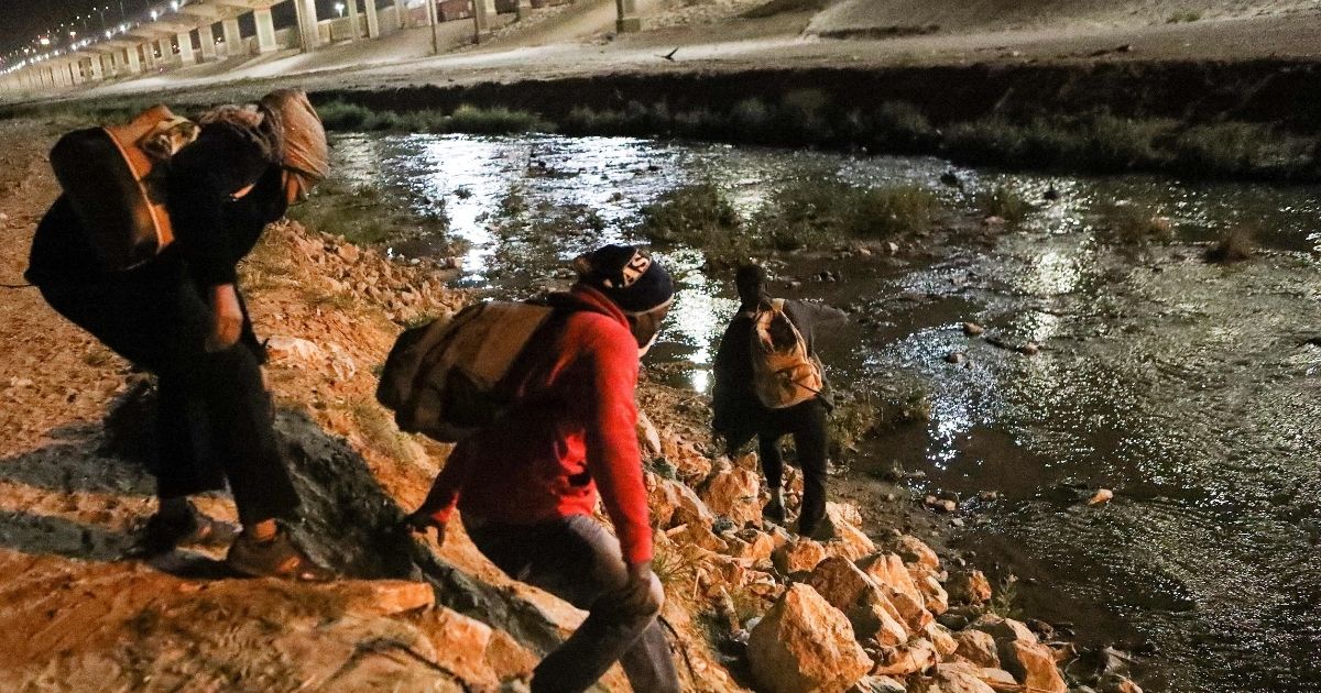 Haitian migrants illegally cross the Rio Bravo in an attempt to get from Ciudad Juarez, in the Mexican state of Chihuahua, to El Paso, Texas, on March 30.