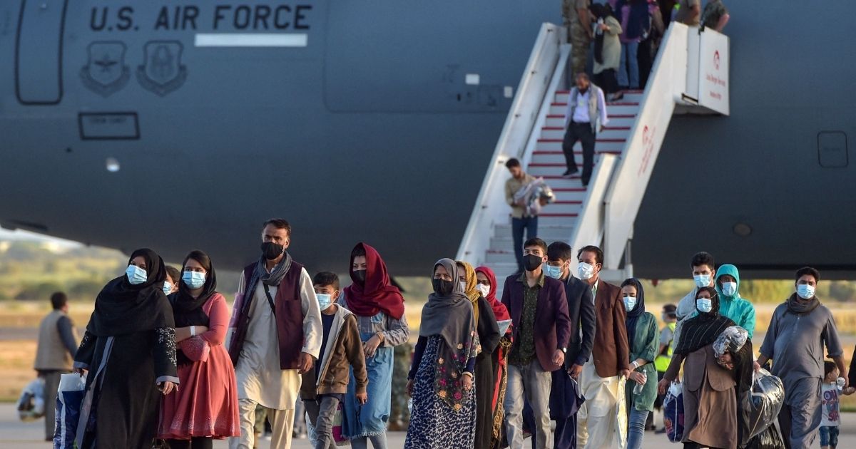 Refugees disembark from a U.S. Air Force aircraft after an evacuation flight from Kabul at the Rota naval base in Rota, southern Spain, on Aug. 3.