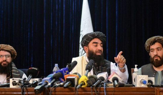 Taliban spokesperson Zabihullah Mujahid (C) gestures as he addresses the first press conference in Kabul on Aug. 17.