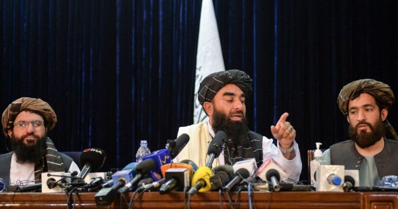 Taliban spokesperson Zabihullah Mujahid (C) gestures as he addresses the first press conference in Kabul on Aug. 17.