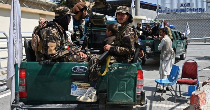 Taliban fighters patrol outside the Kabul International Cricket Stadium during the Twenty20 cricket trial match being played between the two Afghan teams 'Peace Defenders' and 'Peace Heroes' in Kabul on Sept. 3.