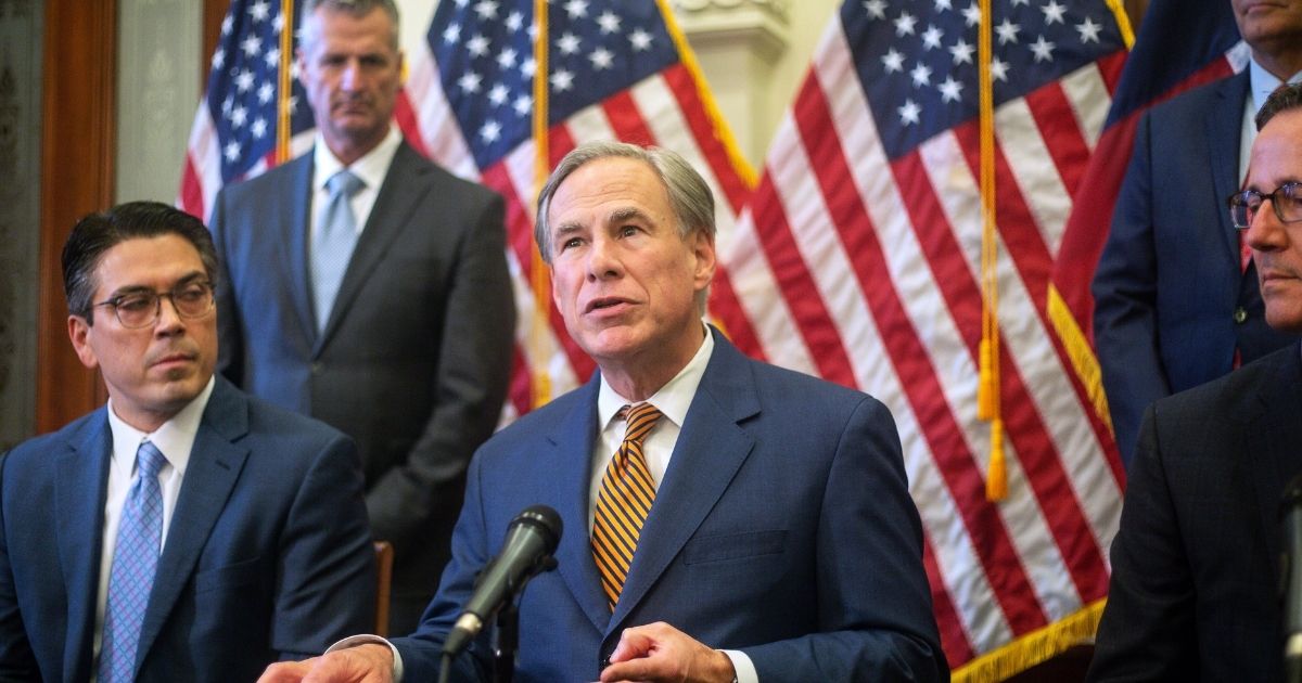 State Rep. Chris Paddie, Texas Gov. Greg Abbott and State Senator Kelly Hancock attend a press conference where Abbott signed Senate Bills 2 and 3 at the Capitol on June 8, in Austin, Texas.