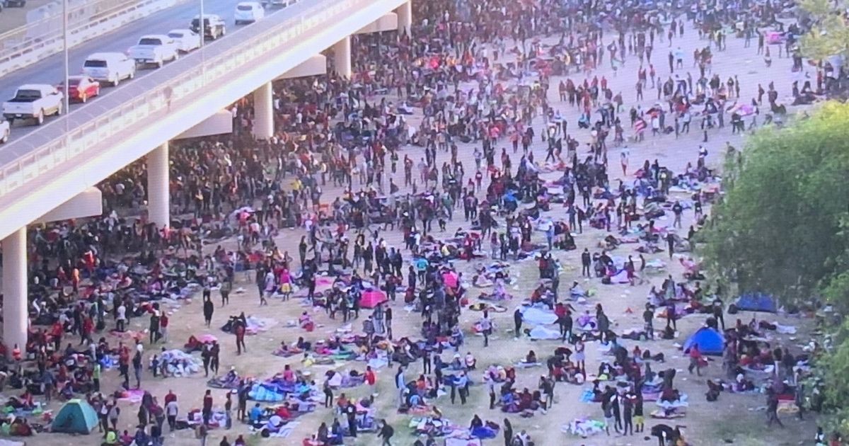 Migrants gather under the Del Rio International Bridge in Del Rio, Texas, on Thursday.
