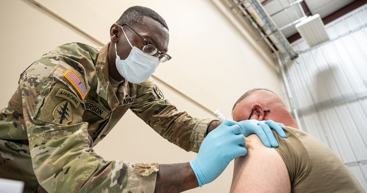 Preventative Medicine Services NCOIC Sergeant First Class Demetrius Roberson administers a COVID-19 vaccine to a soldier on Sept. 9, in Fort Knox, Kentucky.