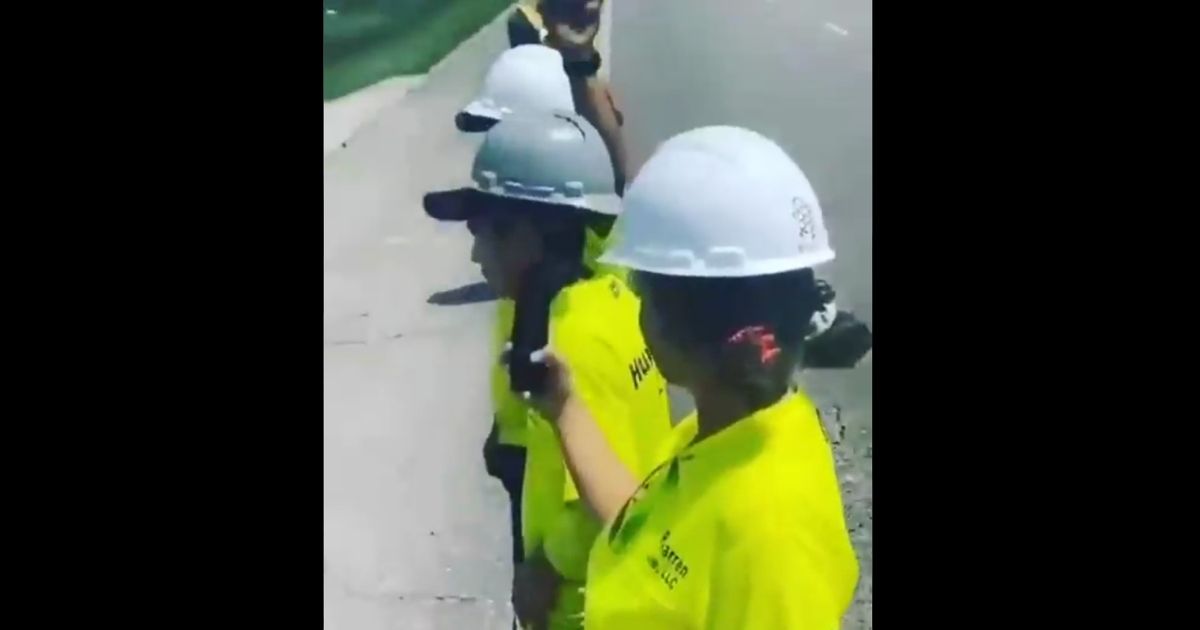 Utility workers appear to turn their backs on President Joe Biden's motorcade after the president traveled to Louisiana in the wake of Hurricane Ida.