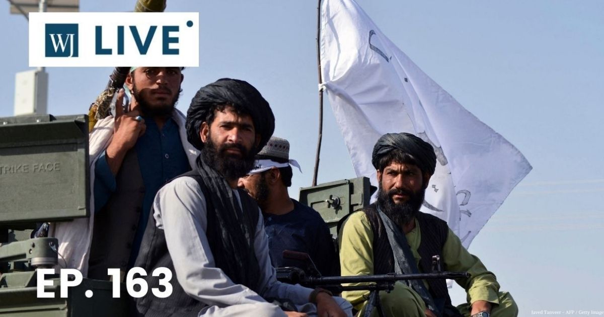 Taliban fighters stand on an armoured vehicle parade along a road to celebrate after the U.S. pulled all its troops out of Afghanistan, in Kandahar on Wednesday following the Taliban's military takeover of the country.