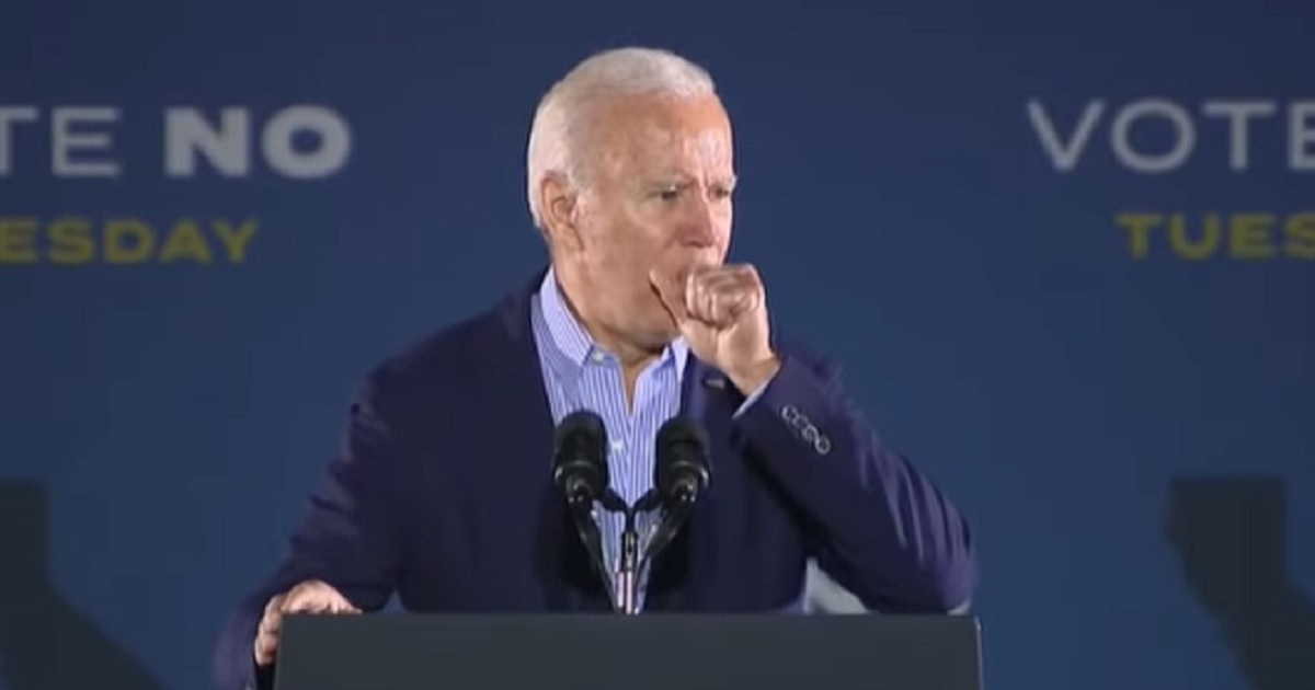 President Joe Biden coughs into his hand during a speech Monday supporting California Gov. Gavin Newsom.