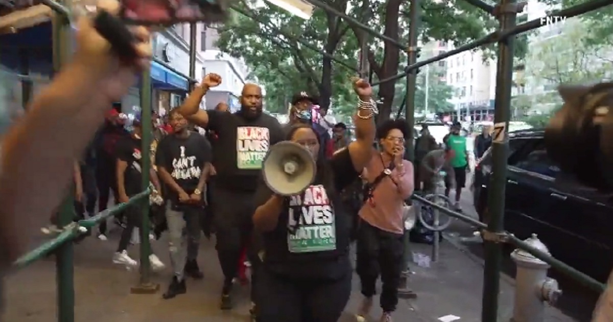 Black Lives Matter protesters demonstrate outside a New York City restaurant on Monday after a melee broke out last week between black diners and restaurant staff over proof of COVID-19 vaccination.