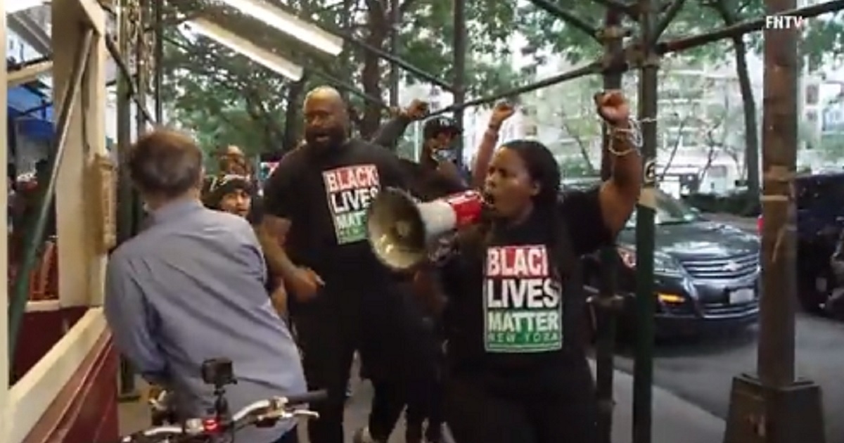 Black Lives Matter activists protest outside a New York City restaurant on Monday.