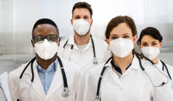 Health care workers are seen in the above stock image.