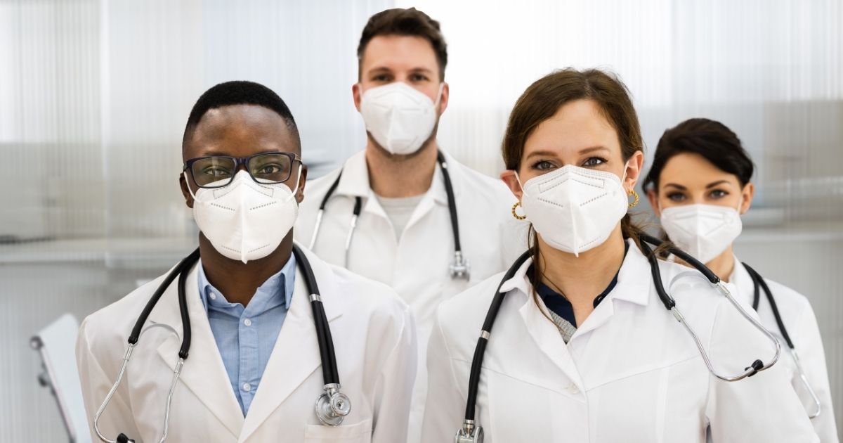 Health care workers are seen in the above stock image.