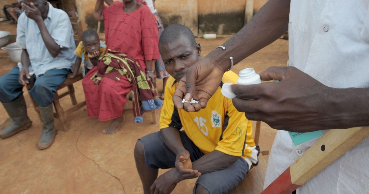 A nurse distributes ivermectin on Sept. 27, 2008, in Kouadioa-Allaikro, Ivory Coast.