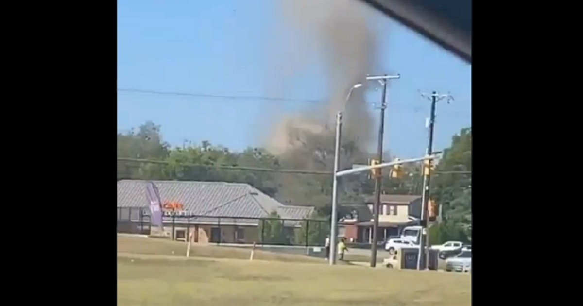 Smoke rises from the scene of a Navy jet crash Sunday in Lake Worth, Texas.