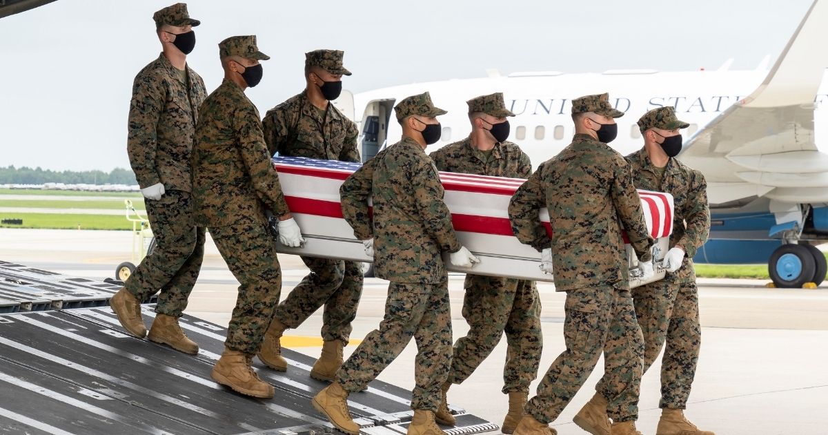 A group of Marines transfers the remains of Marine Corps Cpl. Daegan W. Page of Omaha, Nebraska, on Aug. 29, 2021, at Dover Air Force Base, Delaware.