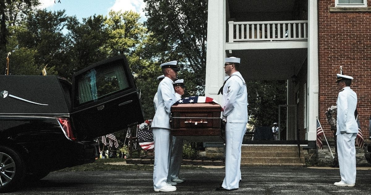 Members of the Navy handle a coffin containing the body of Corpsman Max Soviak on Wednesday in Berlin Heights, Ohio. Soviak was one of 13 U.S. service members killed in Kabul, Afghanistan, on Aug. 26, 2021.