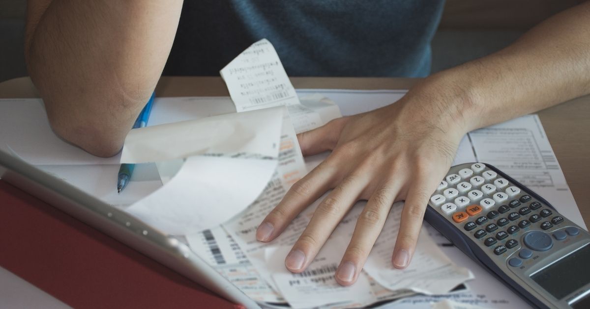 A man pores over his finances in this stock image.
