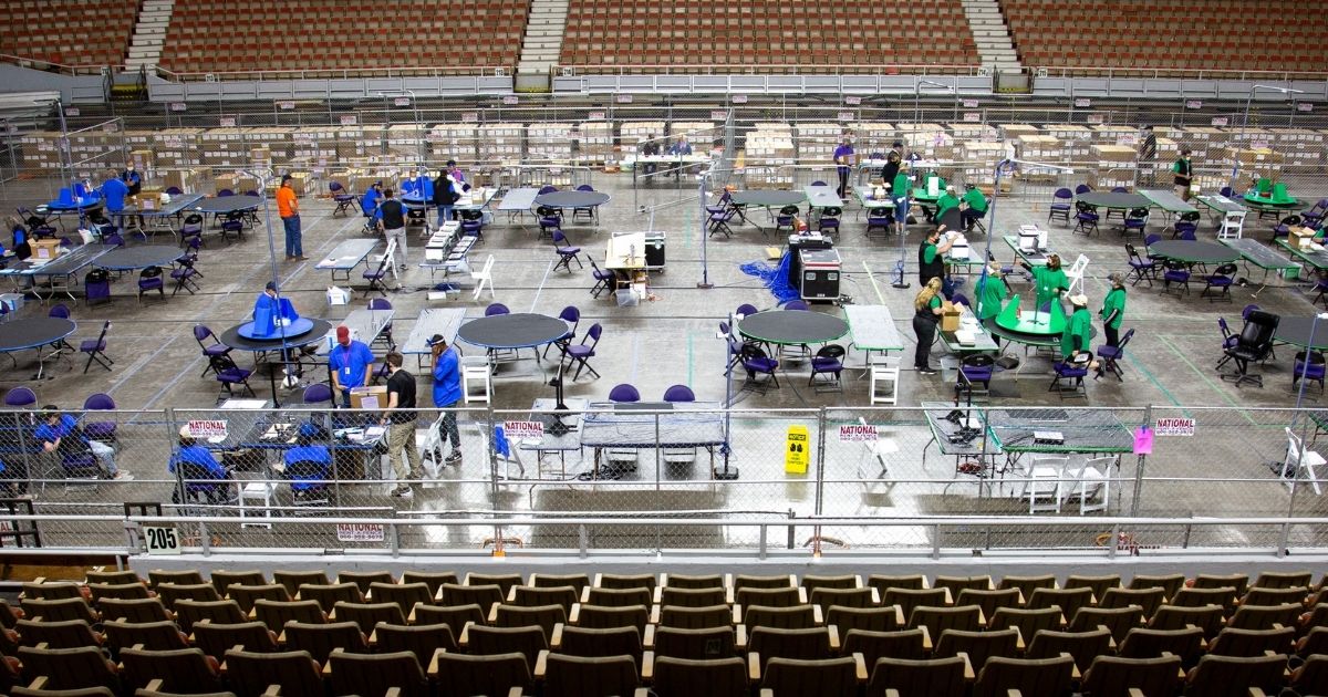 Contractors working for Cyber Ninjas examine and recount ballots from the 2020 general election at Veterans Memorial Coliseum on May 1, 2021, in Phoenix.