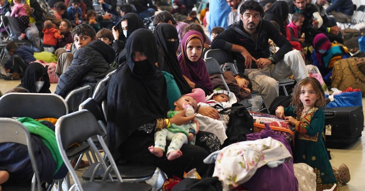 Groups of Afghan refugees wait to be processed on Ramstein Air Base, Germany, on Sept. 8.