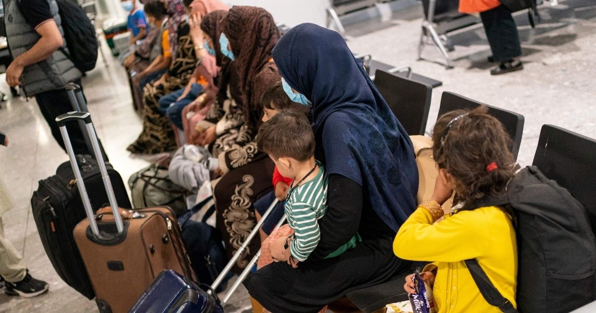 Refugees wait to be processed after arriving on an evacuation flight from Afghanistan at Heathrow Airport in London on Aug. 26.