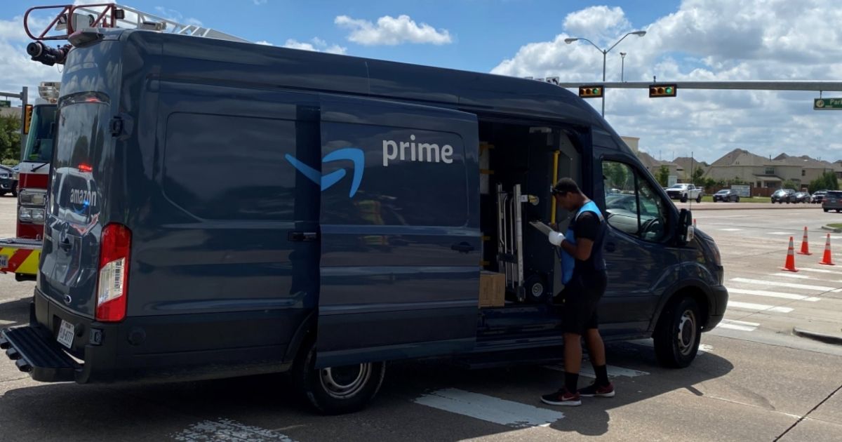 Amazon delivery driver, Tirek Sherman, uses his Amazon Prime van to block lanes of traffic in order to protect a driver in an overturned vehicle on Aug. 27.