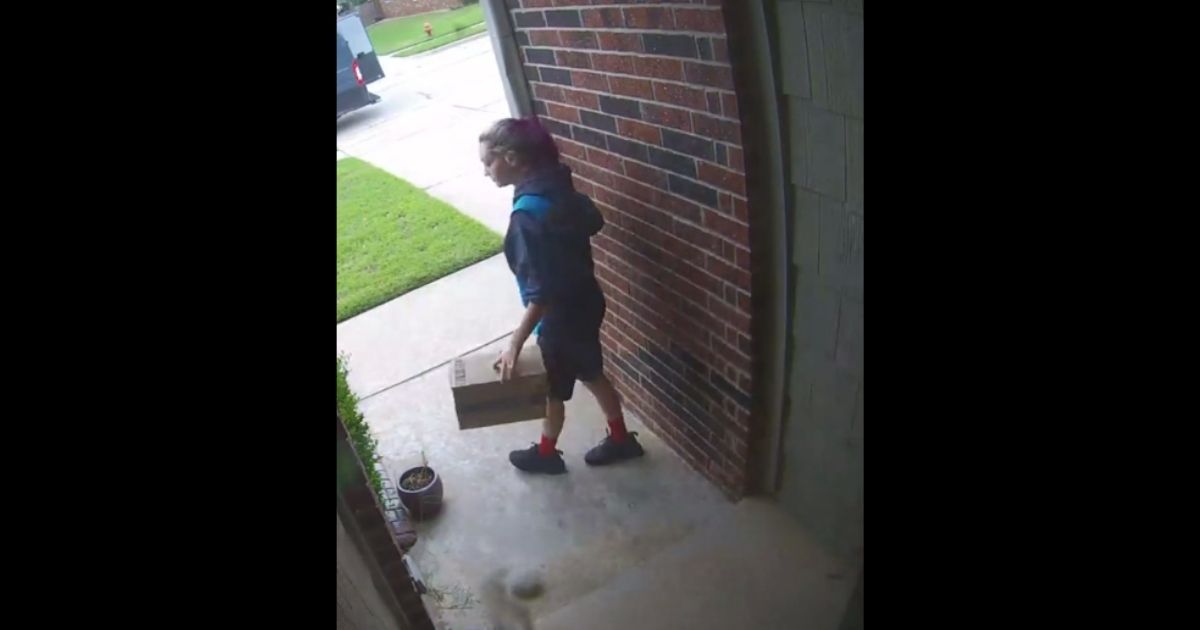 Amazon driver Leeza Hall hides a package after reading instructions to do so on a doormat.