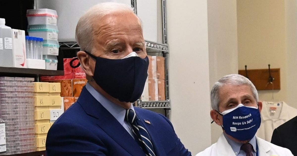 President Joe Biden, left, and Dr. Anthony Fauci tour the Viral Pathogenesis Laboratory at the National Institutes of Health in Bethesda, Maryland, on Feb. 11.