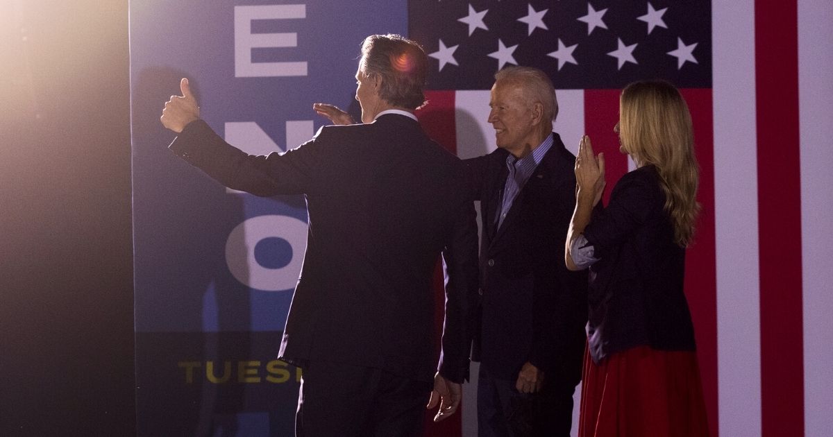California Gov. Gavin Newsom, left, and his wife, Jennifer Lynn Siebel Newsom, along with President Joe Biden, wave to the crowd as they campaign to keep the Democratic governor in office at Long Beach City College in Long Beach on Sept. 13.