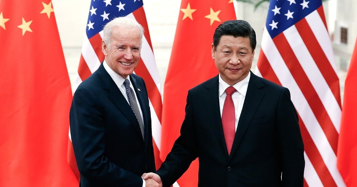 Chinese President Xi Jinping, right, shakes hands with then-Vice President Joe Biden inside the Great Hall of the People on Dec. 4, 2013, in Beijing, China.