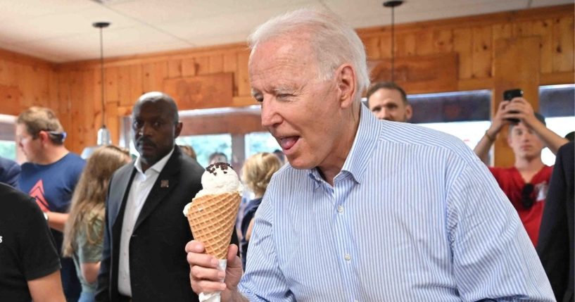 President Joe Biden eats ice cream at Moomers Homemade Ice Cream in Traverse City, Michigan, in this file photo from July 3. Biden has found time for numerous vacations and weekend getaways, but claims he has not had time to make the short trip to America's southern border to witness the humanitarian crisis of his own making.