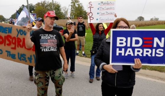 Pro- and anti-Biden protesters are seen in Howell, Michigan, as the president arrives for a visit on Tuesday.