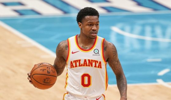 Atlanta Hawks guard Brandon Goodwin brings the ball up court against the Charlotte Hornets in the first half of an NBA basketball game in Charlotte, North Carolina, on April 11, 2021.