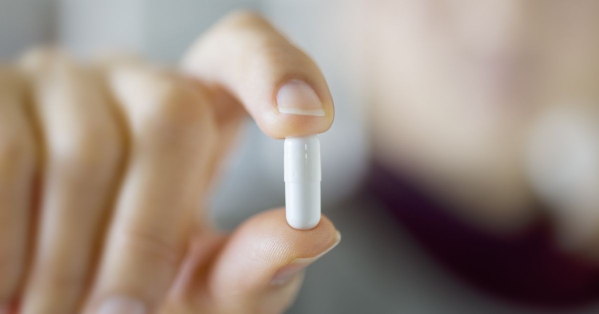 This stock image shows a pill being held up. Pharmaceutical company Merck & Co. plans to seek emergency use authorization for an antiviral COVID-19 therapy that can be taken orally from home.