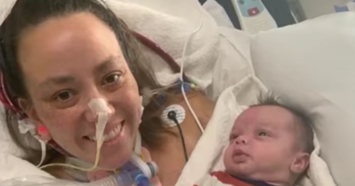 Autumn Carver beams as she holds her newborn son Huxley for the first time. Huxley was delivered Aug. 27 by C-section at an Indianapolis hospital as Autumn fought for her life against COVID-19.