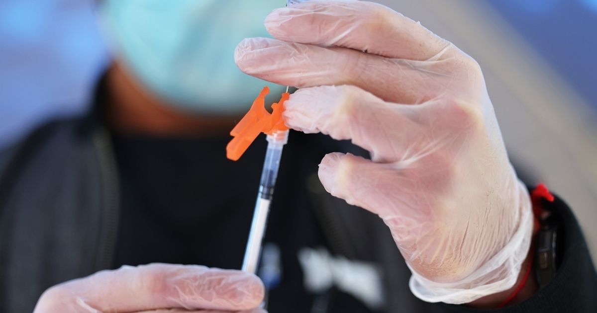 A medical professional prepares a Pfizer-BioNTech COVID-19 vaccine on Oct. 21 in New York City.