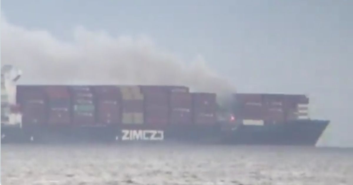 A fire is seen on board the Zim Kingston off of the coast of Washington on Saturday.