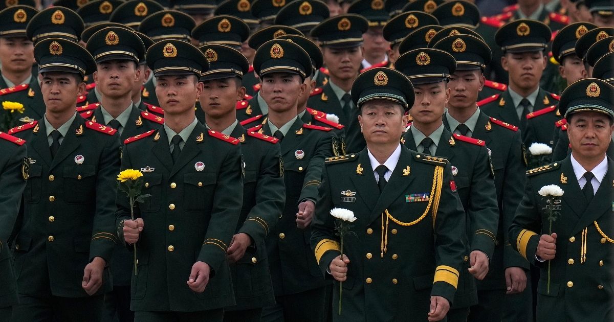Chinese military officers and paramilitary policemen attend a ceremony for Martyr's Day at Tiananmen Square in Beijing, China on Sept. 30.