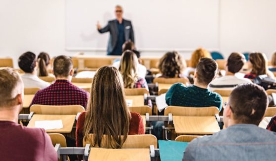 A classroom of college students is pictured in the stock image above.