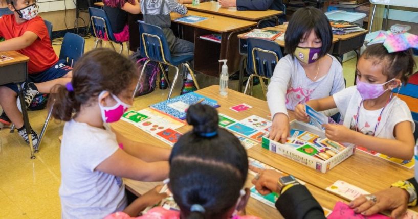 In August, a group of second grade students work in their California classroom while wearing masks.