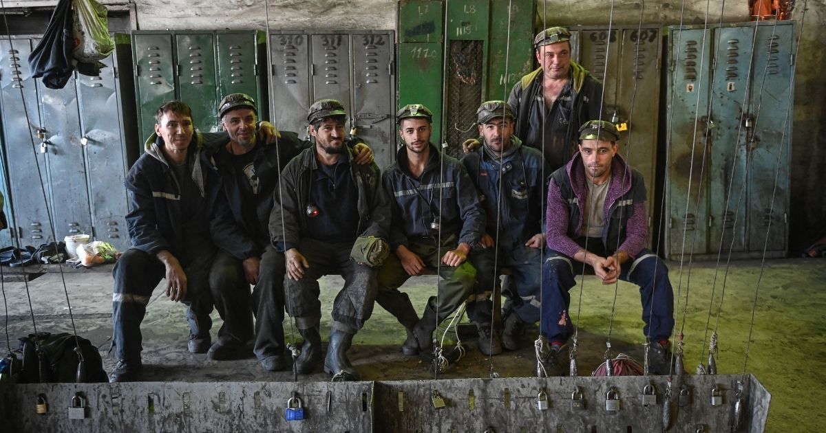 Miners pose for a photo in the locker room prior to entering the shift at Lonea coal mine in Petrila, Romania, one of the coal mining cities located in the mountain area of Valea Jiului on Nov. 24, 2020.